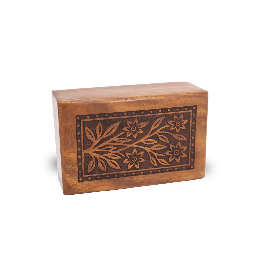 A rectangular wooden keepsake box with a warm medium-brown finish, featuring an inlaid dark brown floral vine pattern on the front face, set against a plain white background.